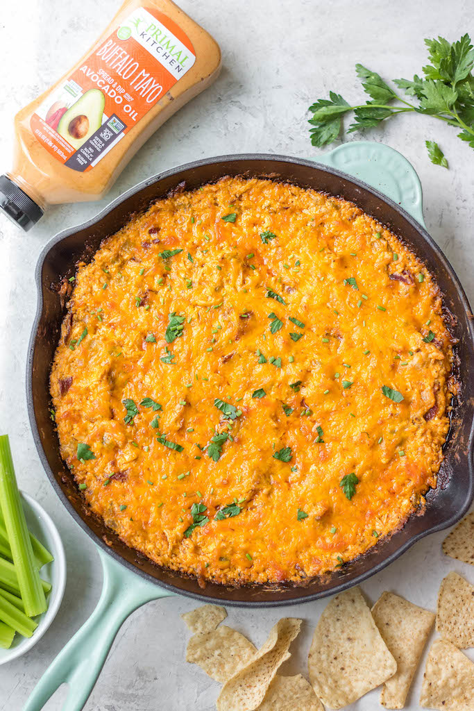 This smoked buffalo chicken dip recipe is so easy and always a crowd pleaser! With only 10 ingredients, it's a simple appetizer that can also be used in tacos, quesadillas, wraps and more. It doesn't take all day on the smoker making it perfect for a family summer gathering, and cooking it on a pellet grill infuses the perfect amount of smoke flavor! It's also low carb and gluten free! #buffalochickendip #smokerbuffalochickendip #buffalochickenrecipes