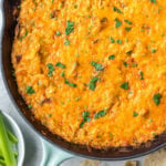 This smoked buffalo chicken dip recipe is so easy and always a crowd pleaser! With only 10 ingredients, it's a simple appetizer that can also be used in tacos, quesadillas, wraps and more. It doesn't take all day on the smoker making it perfect for a family summer gathering, and cooking it on a pellet grill infuses the perfect amount of smoke flavor! It's also low carb and gluten free! #buffalochickendip #smokerbuffalochickendip #buffalochickenrecipes