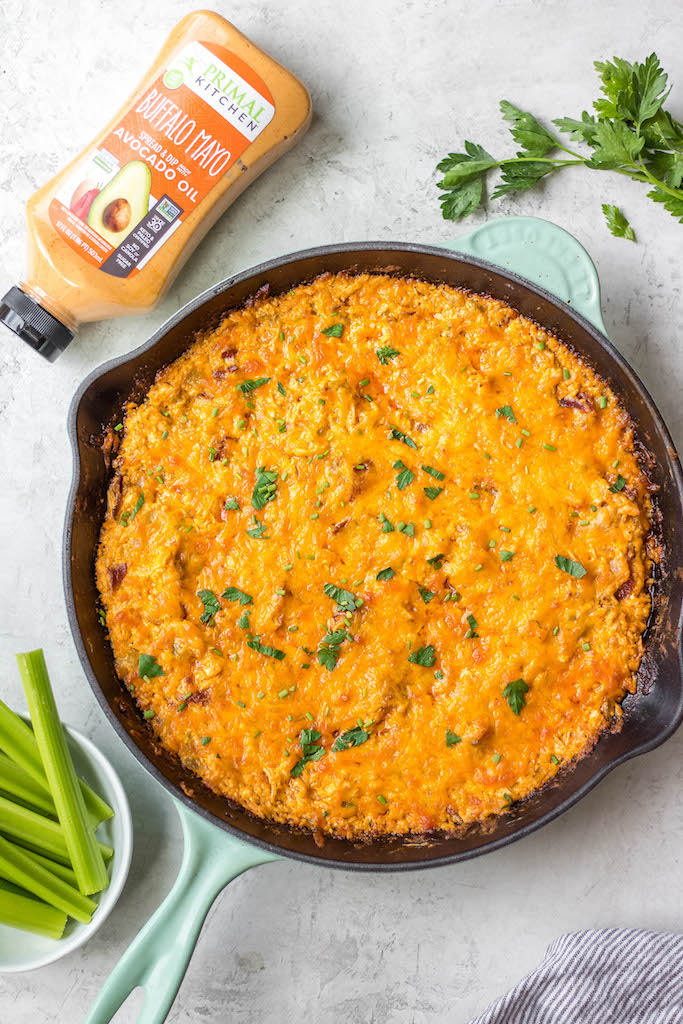 This smoked buffalo chicken dip recipe is so easy and always a crowd pleaser! With only 10 ingredients, it's a simple appetizer that can also be used in tacos, quesadillas, wraps and more. It doesn't take all day on the smoker making it perfect for a family summer gathering, and cooking it on a pellet grill infuses the perfect amount of smoke flavor! It's also low carb and gluten free! #buffalochickendip #smokerbuffalochickendip #buffalochickenrecipes