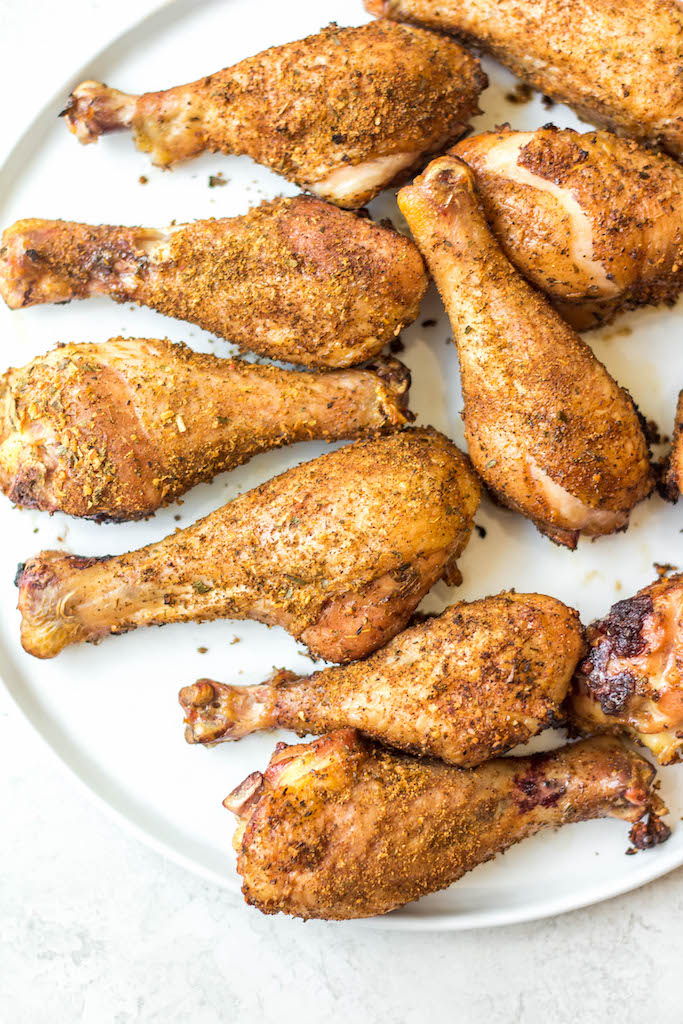 Having a go-to smoked chicken legs recipe is a must have for summer. These smoked chicken legs use very few staple ingredients and is gluten free and dairy free. It's the perfect choice for a gathering, or for meal prep because it is super easy and fast. Smoked chicken drumsticks are a favorite for kids and adults alike and will be a versatile addition to your summer smoking. #smokerrecipes #chickenlegs #glutenfreerecipes #dairyfreerecipes #smokedchickenlegs #chickendrumsticks