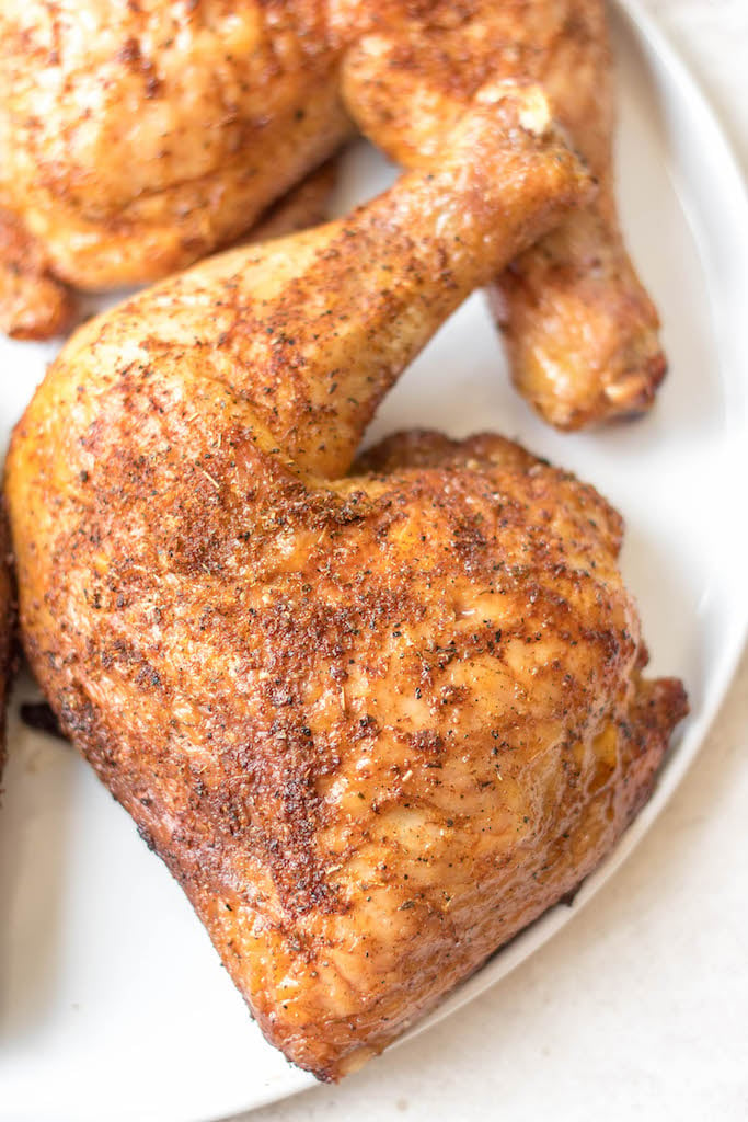 Making smoked chicken quarters is an easy way to feed your group. They take less time to cook than a full chicken and are already portioned! This recipe is gluten free and dairy free and takes almost no prep time. These smoked chicken leg quarters can pair with almost any side you want and will be a hit for the whole family! #glutenfreerecipes #dairyfreerecipes #glutenfreedairyfreerecipes #healthychickenrecipes #smokerrecipes