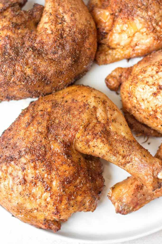 Making smoked chicken quarters is an easy way to feed your group. They take less time to cook than a full chicken and are already portioned! This recipe is gluten free and dairy free and takes almost no prep time. These smoked chicken leg quarters can pair with almost any side you want and will be a hit for the whole family! #glutenfreerecipes #dairyfreerecipes #glutenfreedairyfreerecipes #healthychickenrecipes #smokerrecipes