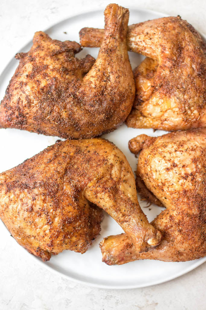 Making smoked chicken quarters is an easy way to feed your group. They take less time to cook than a full chicken and are already portioned! This recipe is gluten free and dairy free and takes almost no prep time. These smoked chicken leg quarters can pair with almost any side you want and will be a hit for the whole family! #glutenfreerecipes #dairyfreerecipes #glutenfreedairyfreerecipes #healthychickenrecipes #smokerrecipes