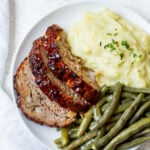 This air fryer meatloaf is a great, healthy recipe for getting a classic meal on the table for dinner. It uses very few ingredients and can be made gluten free easily. The air fryer caramelizes the sauce to perfection and makes for a juicy, flavorful meal. Use this meatloaf for an easy meal prep for the week ahead or divide the recipe into two loaves to save some to freeze for later. #glutenfreerecipes #healthydinnerrecipes #beefrecipes #airfryerrecipes #meatloaf