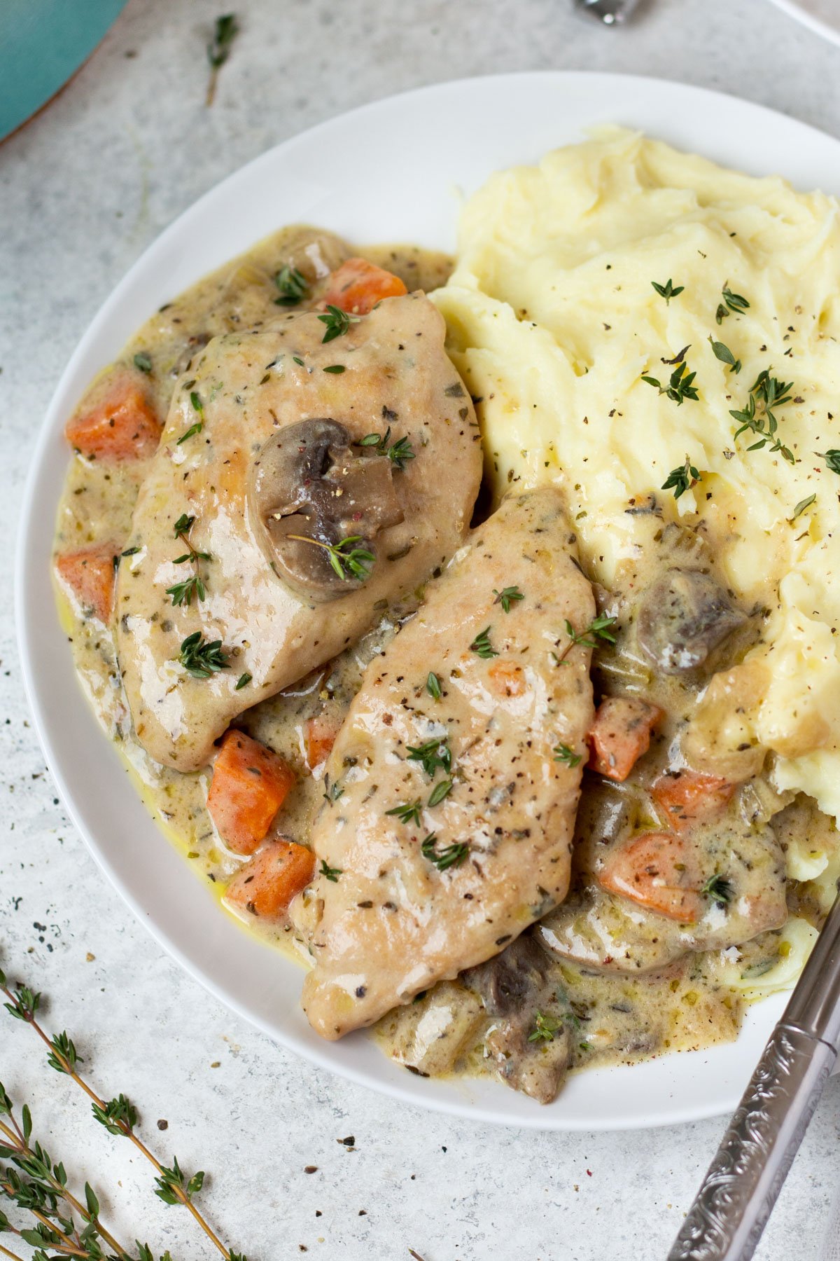 Making dutch oven chicken breast feels like an elevated dinner meal, but it's such an easy recipe to cook! It's a healthy dutch oven recipe that's also Whole30, low carb, gluten free and dairy free, and filled with vegetables like onions, celery and carrots, and the chicken breast is cooked in a creamy parsley and thyme sauce. It's a family friendly recipe that only uses one pot, and comes together in under an hour! #dutchoven #dutchovenchicken #chickenbreast #whole30dinner