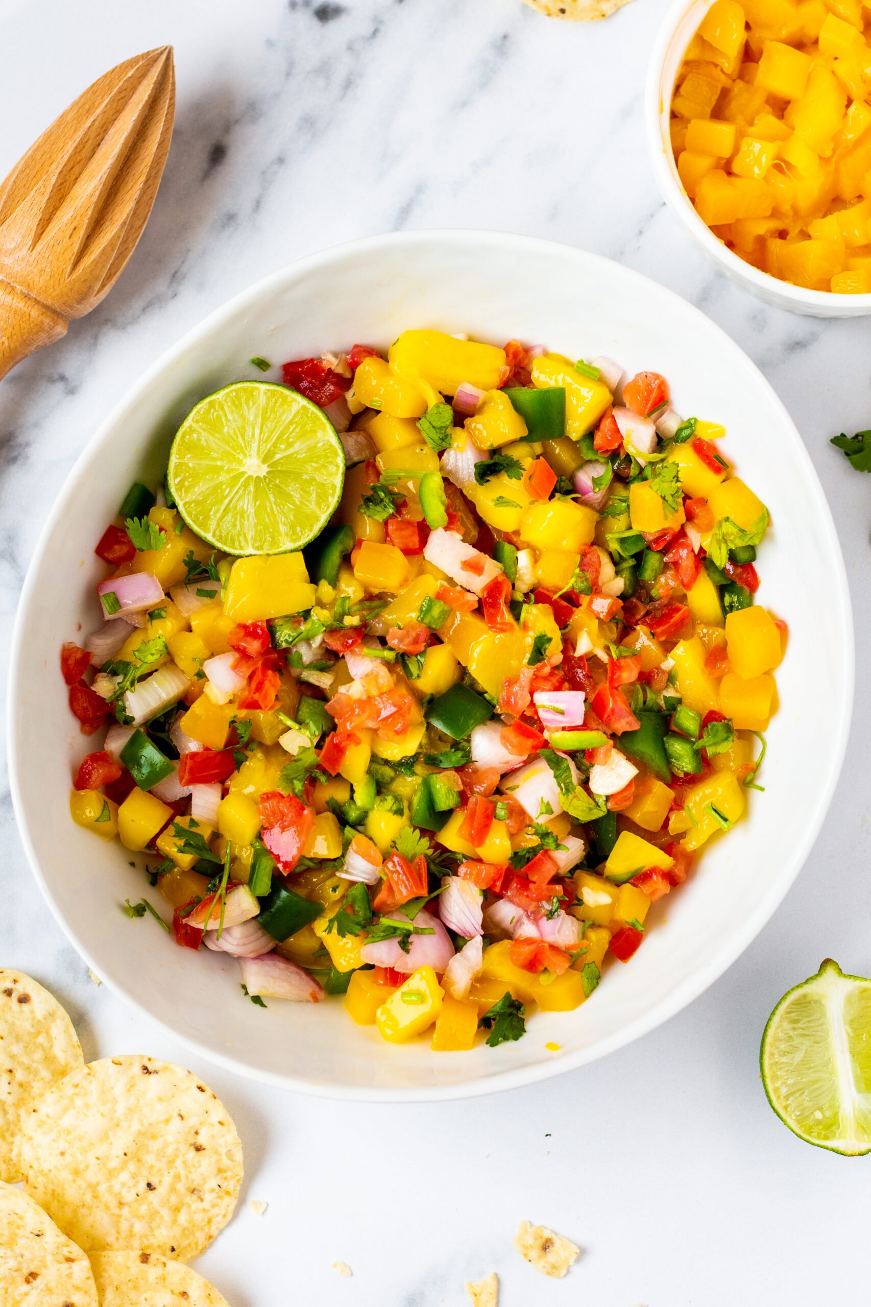 Mango pico de Gallo is the perfect recipe for a change up to regular pico. The slight spice of the jalapeno plays perfectly with the sweetness of the mango and the flavor profile makes it work everywhere pico would go. This paleo and Whole30 recipe is super easy to make and is both gluten free and dairy free. It takes almost no time to make so give this one a try! #glutenfreerecipes #dairyfreerecipes #glutenfreedairyfreerecipes #mango #picodegallo #healthyrecipes