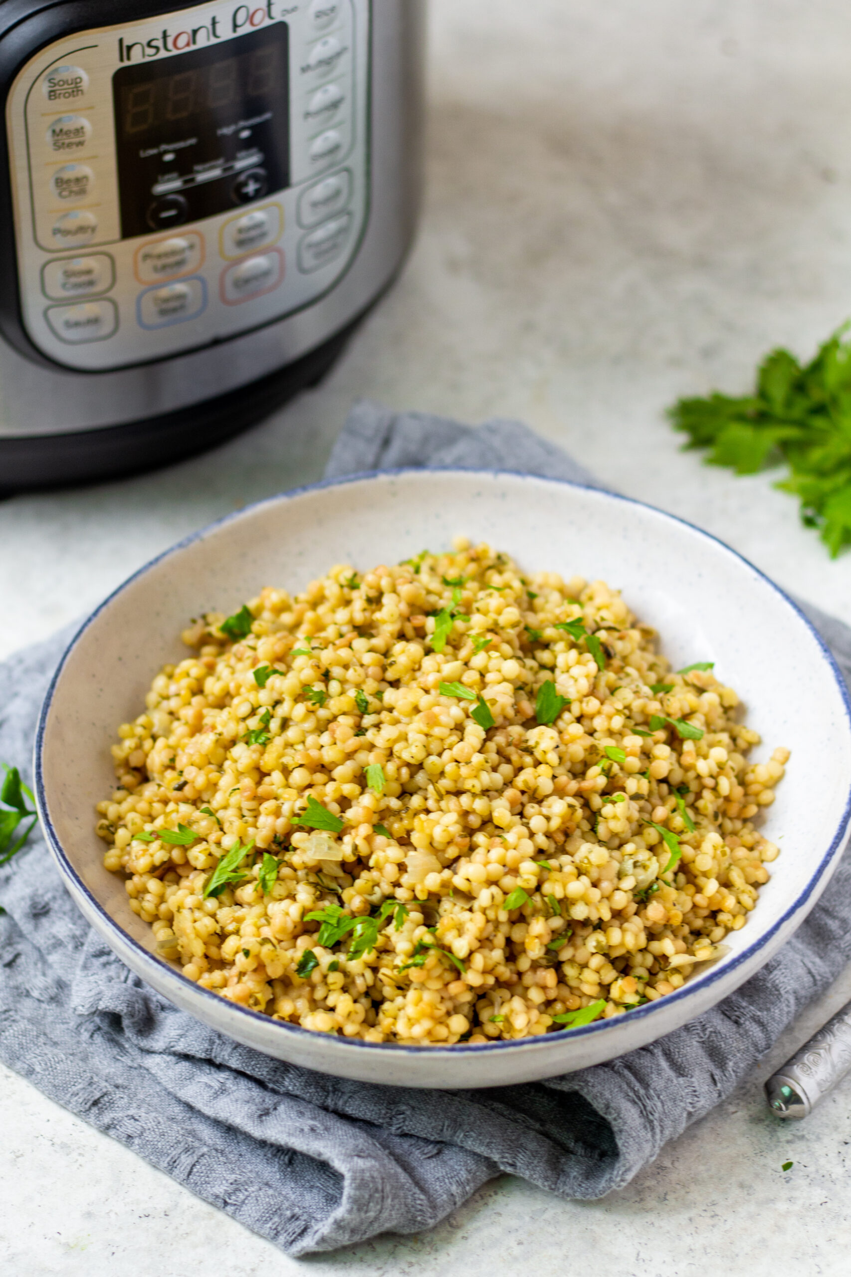 Instant Pot couscous is the best choice for getting an easy side onto your table. This recipe is both dairy free and vegan and is ready in about 15 minutes so it's super quick. Use this recipe as a standalone side for dinner or in any scenario where you'd want a bed of pasta to top with your favorite sauce, salad or recipe. #couscous #pressurecookerrecipes #veganrecipes #dairyfreerecipes #healthypastarecipes #healthyrecipes