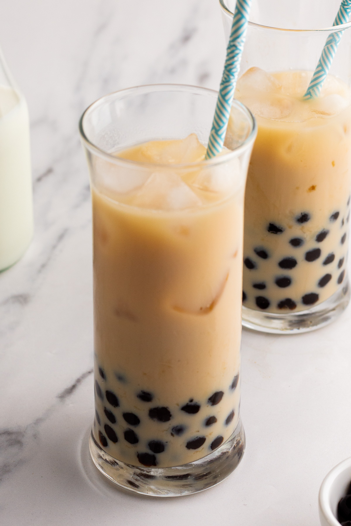 Jasmine milk boba tea is a refreshing drink that is naturally gluten free and takes only ten minutes from start to finish. It both looks great and is simple to make. The touch of sweetness from the boba (tapioca pearls) combine with the milk and floral notes of the jasmine tea make it a perfect drink for an afternoon treat or anytime. #boba #tapiocapearls #bubbletea #glutenfreerecipes #easydrinkrecipes #jasminetea #bobatea