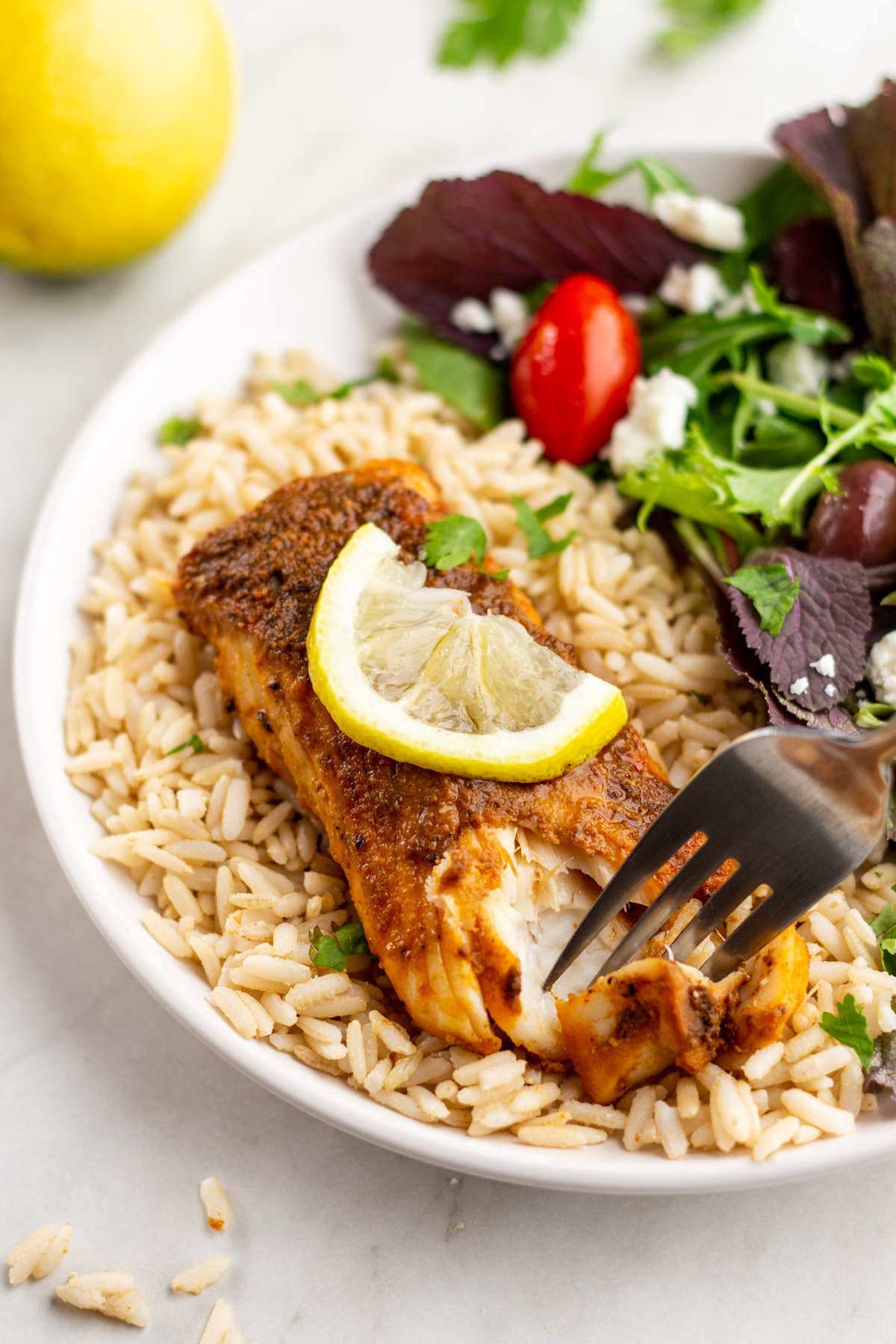 Air fryer halibut is easily a winning recipe. This recipe is gluten free, dairy free, low carb, and Whole30 compliant. It takes 10 minutes from start to finish using only a few pantry staples for ingredients. You can effortlessly scale the recipe to feed as many people as necessary or to meal prep for the week ahead. #airfryerhalibut #glutenfreefish #whitefishrecipes #fishmealprep #easymealprep #10minutemeals