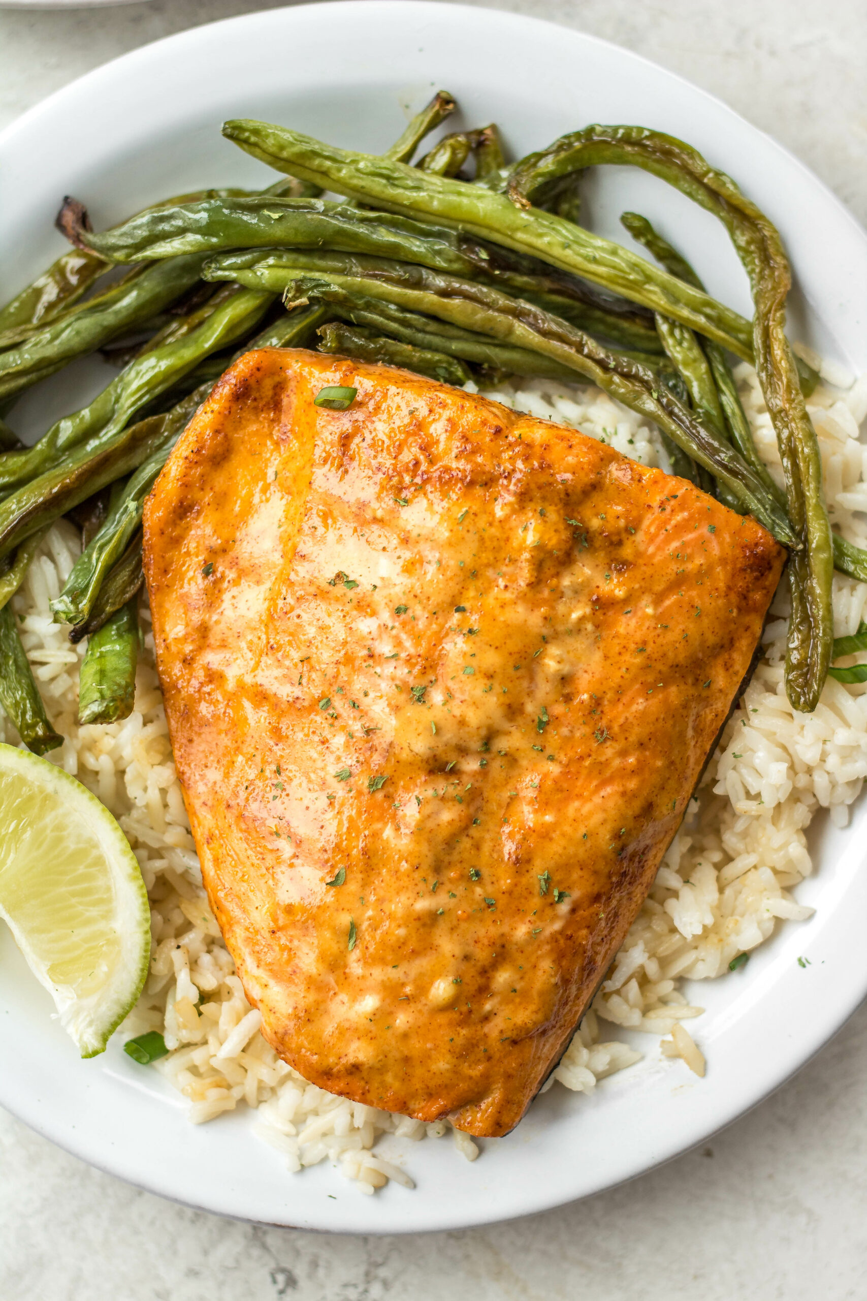Bang Bang salmon with homemade Bang Bang sauce is both dairy free and gluten free. It takes about 10 minutes to cook and uses only a few easy ingredients. Made in the oven on a sheet pan, it's a breeze for cleanup and makes for an easy win for meal prep or dinner anytime. #homemadebangbangsauce #glutenfreesalmon #diaryfreesalmon #salmonrecipes #10minutemeals #bangbangsalmon