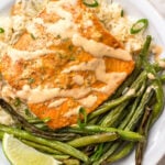 Bang Bang salmon with homemade Bang Bang sauce is both dairy free and gluten free. It takes about 10 minutes to cook and uses only a few easy ingredients. Made in the oven on a sheet pan, it's a breeze for cleanup and makes for an easy win for meal prep or dinner anytime. #homemadebangbangsauce #glutenfreesalmon #diaryfreesalmon #salmonrecipes #10minutemeals #bangbangsalmon