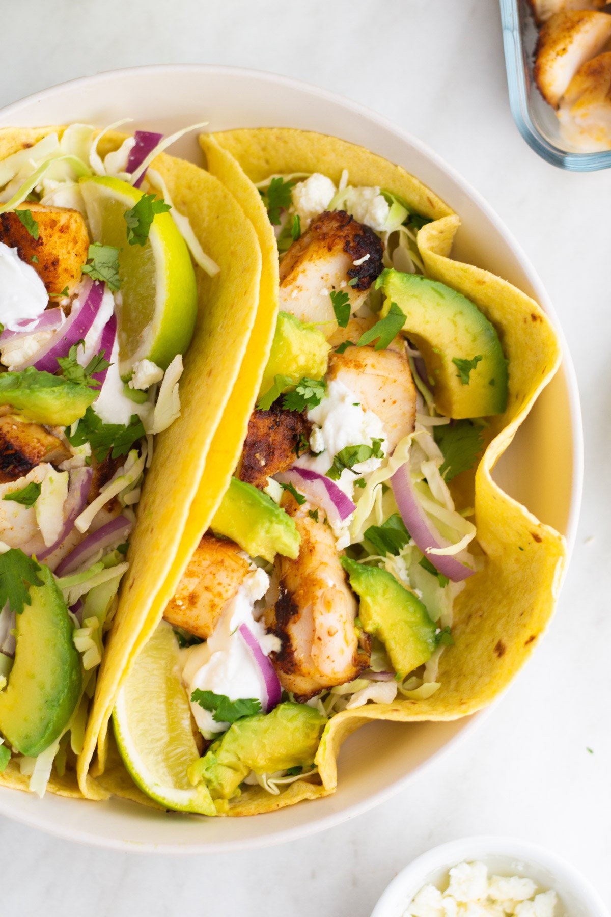 Halibut fish tacos are perfect for an easy weeknight meal. This recipe takes only ten minutes to make and is both dairy and gluten free, along with paleo, Whole30 and low carb. The homemade dairy free sour cream in this recipe is incredibly simple to make and works perfectly with the halibut fillets. Fish tacos are perfect to make for family meals, large and small, or to meal prep for the week ahead. #fishtacos #halibut #easyhalibutrecipes #10minutemeals #glutenfreerecipes #dairyfreerecipes #glutenfreedairyfreerecipes #easydinnerrecipes